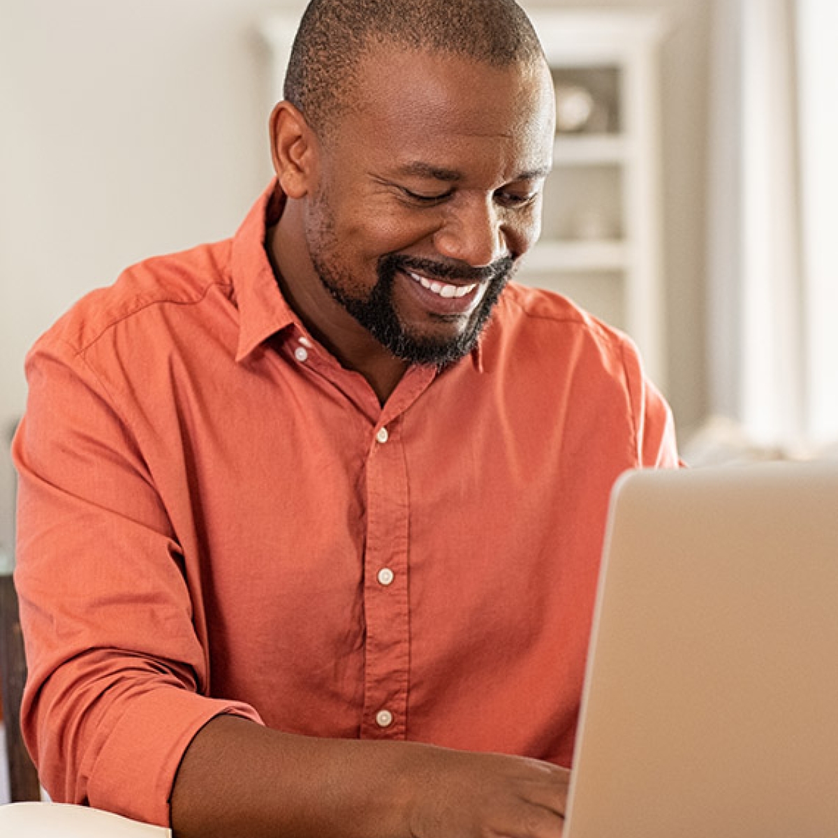Happy mature man using laptop